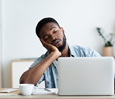 Man falling asleep at work