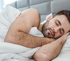 man sleeping in a bed