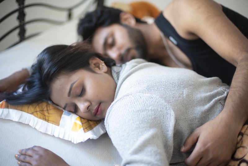 man and woman practicing healthy sleep habits 