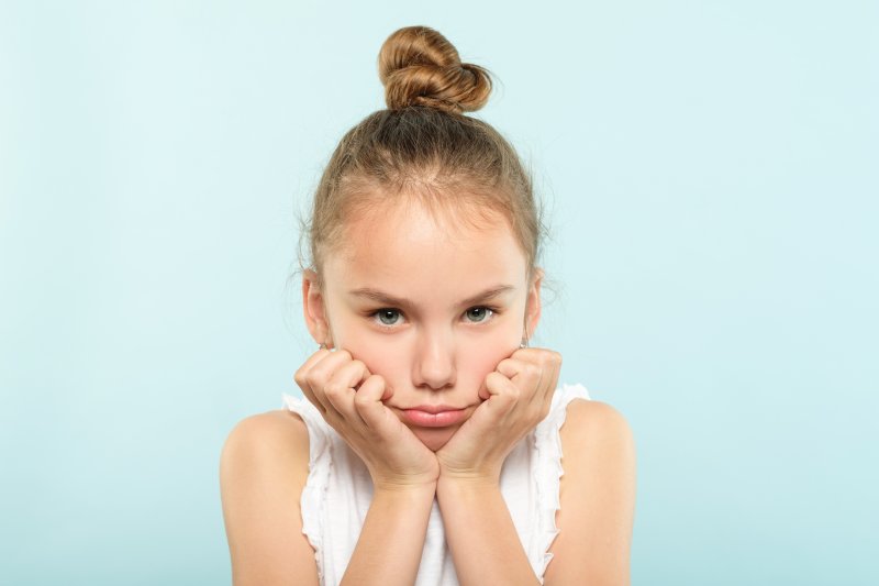 young girl looking grumpy  