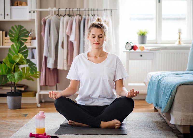 woman meditating in her bedroom  