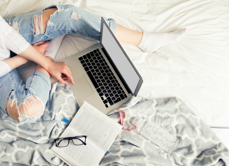 person working on a laptop in bed