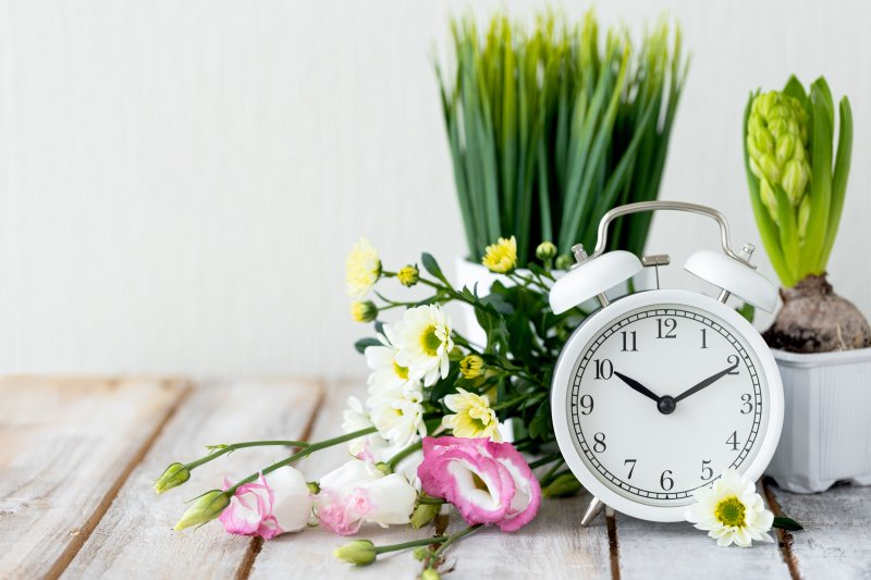 clock surrounded by spring flowers 