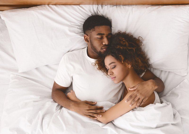 young couple sleeping in bed 