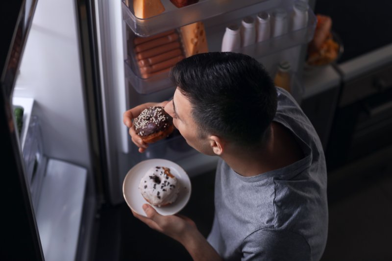 man eating sweets from fridge 
