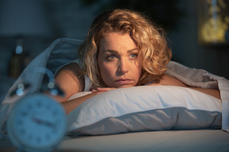 woman lying in bed awake 