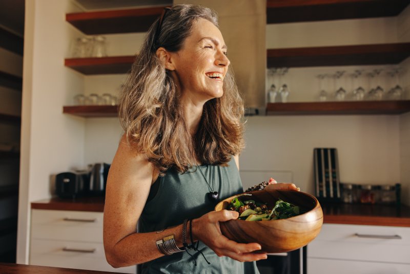 middle-aged woman eating a salad