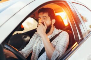 tired driver yawning in the morning