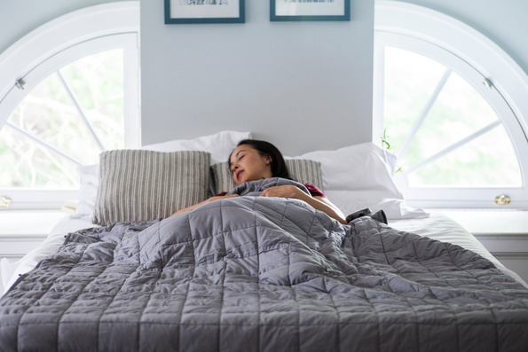 woman sleeping with weighted blanket 