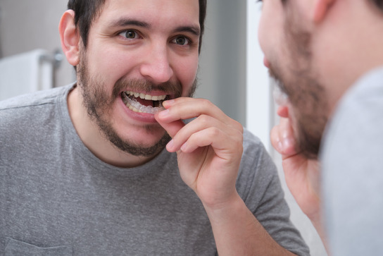 person holding oral appliance in hand